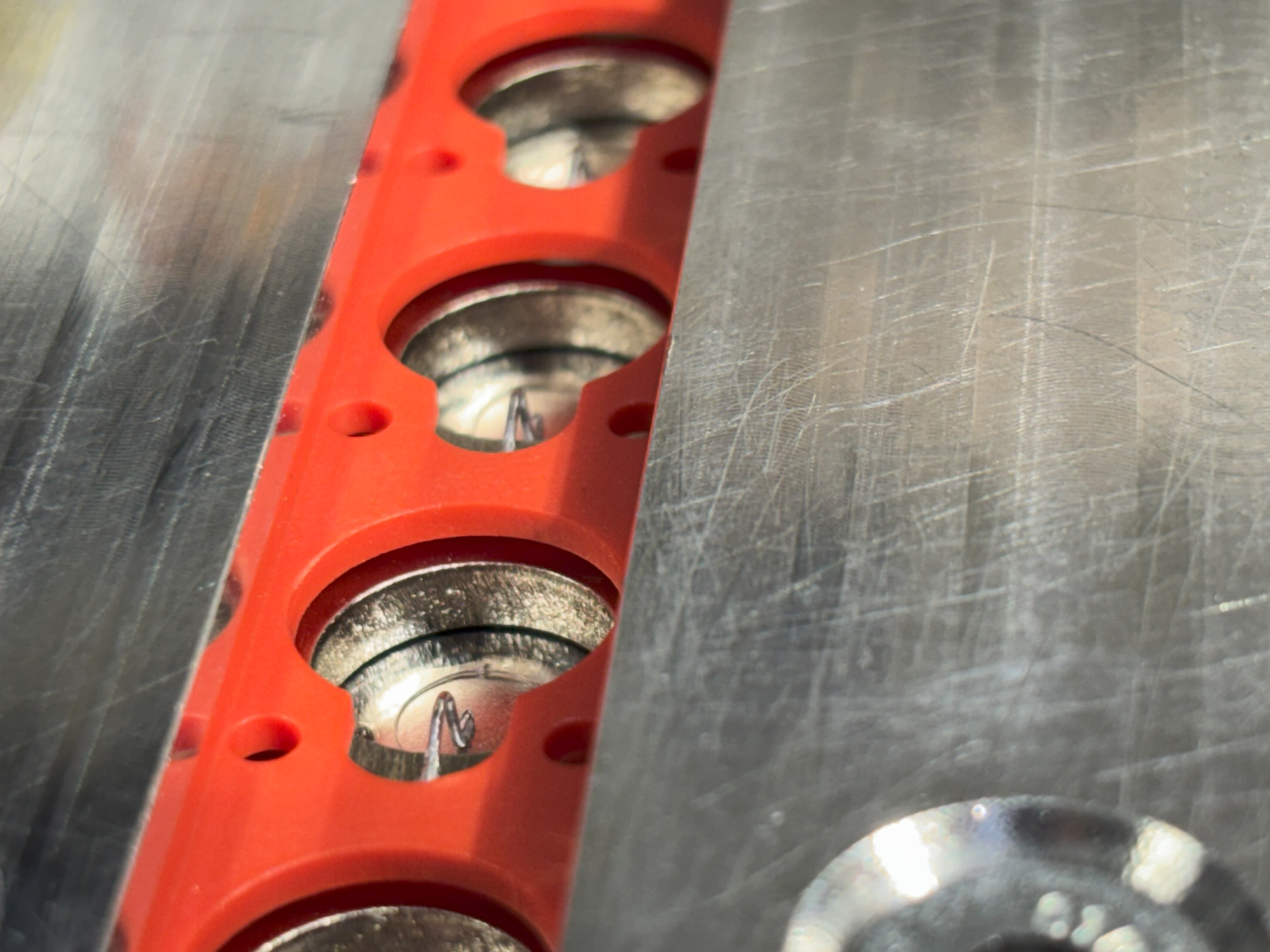 Wide view of completed lithium block module showing multiple wire bonds in manufacturing fixture