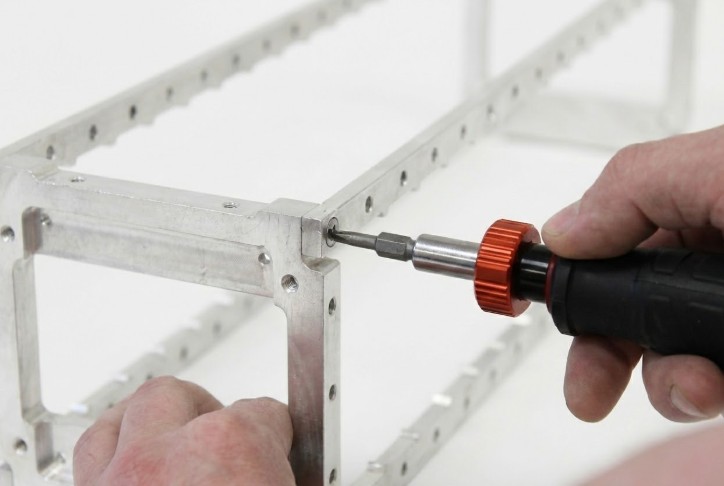 Proper torquing technique showing downward pressure being applied while torquing